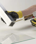 Applying 3M Scotch-Weld Clear Epoxy Adhesive DP100 Plus with High Sheer and Peel Strength to metal surface, using dispensing tool, close-up view.