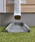 Heavy Duty Two Pack Premium Rubber Downspout Splash Blocks Built Damn Tough With A Slick Stone Texture For Top Shelf Yard Drainage And Clean Rainwater Management In Gray on green grass under gutter.
