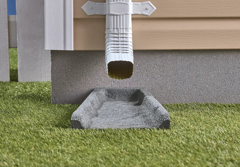 Heavy Duty Two Pack Premium Rubber Downspout Splash Blocks Built Damn Tough With A Slick Stone Texture For Top Shelf Yard Drainage And Clean Rainwater Management In Gray on green grass under gutter.