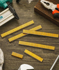 Pro Level 18 Gauge Narrow Crown Staples 7500 Count 1/2 X 1/4 Inch gold staples displayed with tools on wooden surface.