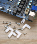 Arcade Console PCB Mounting Feet With Screws White L Shaped Plastic Standoffs on wooden surface with motherboard