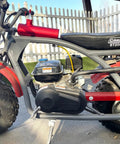 Side view of a mini bike with Three Stage Exhaust Header Pipe Fits 212cc 196cc 224cc Go Karts And Gas Mini Bikes installed.