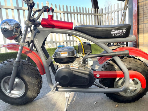 Side view of a mini bike with Three Stage Exhaust Header Pipe Fits 212cc 196cc 224cc Go Karts And Gas Mini Bikes installed.