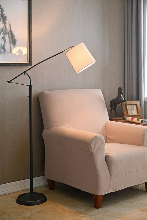 Oil Rubbed Bronze Adjustable Floor Lamp With Swivel Arm, Rustic Style, next to beige armchair, 66 inch tall in living room