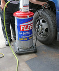 Lincoln 917 Pro Grade 50 To 1 Pneumatic Grease Pump in use with 120 lb drum next to a truck tire