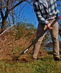 Person using Dual Hoe And Rake Garden Tool With 58 Inch Fiberglass Shaft For Cultivating Soil Breaking Up Compact Dirt Leveling Beds And Yard Cleanup Do It All Yard Tool For Lawn Care And Landscaping Heavy Duty on grass