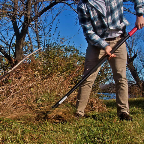Person using Dual Hoe And Rake Garden Tool With 58 Inch Fiberglass Shaft For Cultivating Soil Breaking Up Compact Dirt Leveling Beds And Yard Cleanup Do It All Yard Tool For Lawn Care And Landscaping Heavy Duty on grass