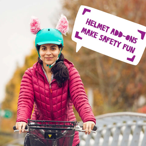 Person wearing a blue helmet with pink fluffy lynx-themed ears, part of Lynx Themed Helmet Ears Accessory Kit With Sticky Hook And Loop Fastener For Snowboarding Skiing And Biking Helmet Not Included Fluffy Bunny Rabbit Ears For Kids Toddlers And Adults To Stand Out On The Slopes, mounted while biking outdoors.