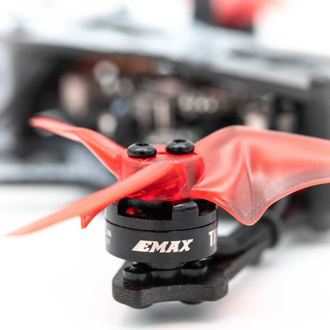 Close-up of red propeller on Micro FPV Racing Drone Ready To Fly Kit With Goggles And Controller, carbon fiber frame.