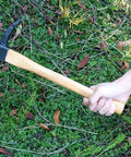 Hand holding Beast Of A Heavy Duty Japanese Hand Forged Steel Pick Axe For Digging And Weeding Gardens, 14-3/4 inch mattock tool.