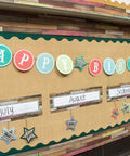 Classroom bulletin board with birthday display, labeled months, stars and letters, Home Sweet Classroom Flat Name Plates 36 Pack For Labels.