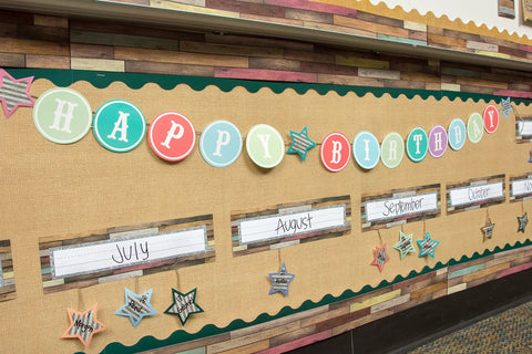 Classroom bulletin board with birthday display, labeled months, stars and letters, Home Sweet Classroom Flat Name Plates 36 Pack For Labels.