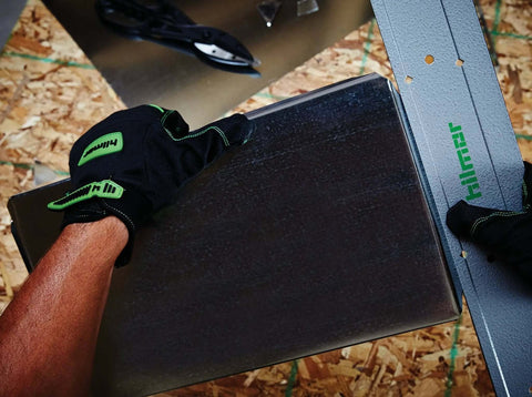 SMTFT24 Folding Tool With Precision Sight Holes For Depth Alignment used on sheet metal, shown cutting with cushioned grip and gloves