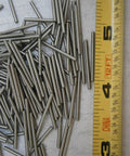 Dowel Pins 1/16 In OD By 0.9 In Long, 303 Stainless Steel Pack Of 25, Ultra Tough Multi Purpose Hardware Fastener Kit For Harsh Environments, Corrosion Resistant, Built To Last, Mercury Free And Non Toxic. 303 stainless steel dowel pins next to ruler