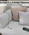 Straight Up Go Fast USB C Extension Cable 6.6 Feet Long in use charging a phone on a couch with decorative pillows.