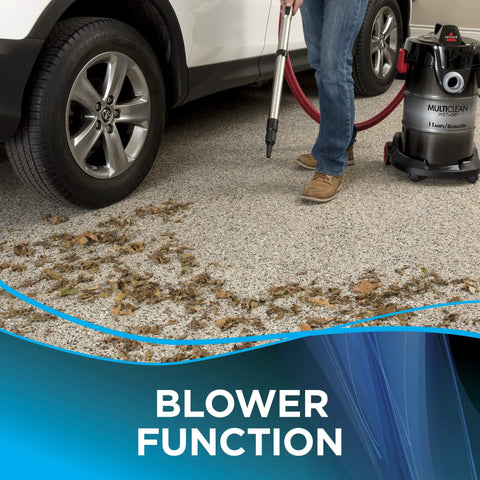 Hella Powerful Wet And Dry Garage Vacuum Featuring 11 Amp Motor And 6 Gallon Tank cleaning leaves with blower function outdoors.