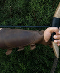 Archery Bracer With Thumb Slot And Adjustable Buckle Straps, Full Grain Leather Forearm Protector in use with bow