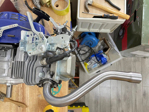 Beefed Up Exhaust Header Pipe For Predator 196cc 212cc GX160 GX200 Go Kart attached to engine, showcasing installation angle.
