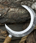 Hand Forged Athame Crescent Blade Sickle for Ritual Work and Herb Harvesting displayed on tree bark with smooth curved edge.