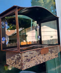 Metal Window Bird Feeder With Wide Viewing Window And Ultra Strong Suction Cups mounted on glass showcasing bird seed