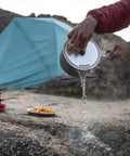 Lightweight Aluminum Two Pot Camping Cook Set With Premium Ceramic Nonstick Coating in use at a campsite