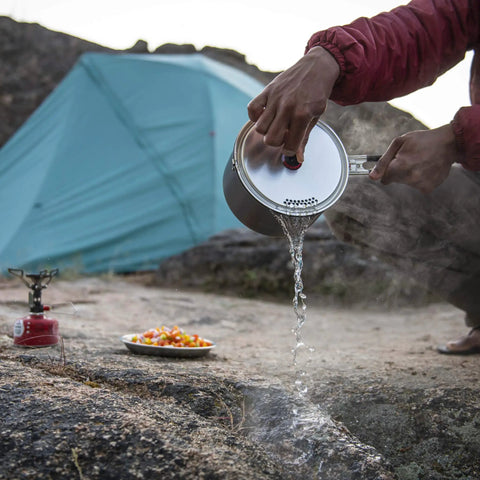 Lightweight Aluminum Two Pot Camping Cook Set With Premium Ceramic Nonstick Coating in use at a campsite