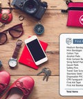 Swiss Safe 2-in-1 first aid kit in red pouch with 64-piece contents list; travel gear like passport, phone, camera nearby.