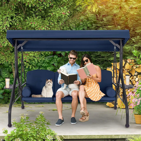 Three Seat Outdoor Porch Swing With Adjustable Canopy And Stand, Convertible Patio Glider Bed With Thick Cushions And Pillow, Upgraded Cup Holder, Heavy Duty All Metal Frame For Backyard Vibes Blue with couple and cat reading.