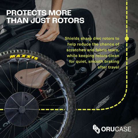 Person placing MTB with Travel Rotor Guard For Mountain Bikes Disc Rotor Protector in a travel case.