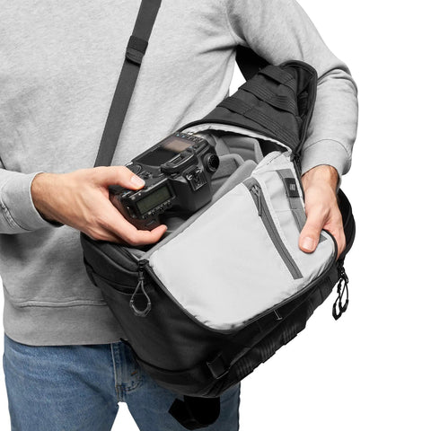 Person using ProTactic BP 300 AW II Mirrorless And DSLR Backpack With QuickShelf Divider System for Canon camera storage