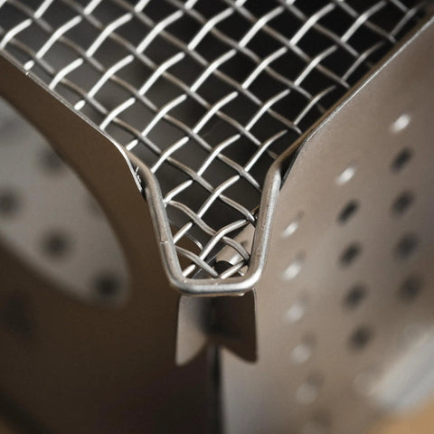 Close-up of the mesh top of Ultralight Titanium Camping Stove 7.7oz Flatpack Wood Burning Stove for Backpacking and Hiking.