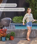 Woman using Classic Charcoal 100ft Automatic Retractable Garden Hose Reel With One-Half Inch UV Stabilized Kink-Free Hose.