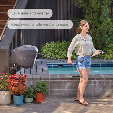 Woman using Classic Charcoal 100ft Automatic Retractable Garden Hose Reel With One-Half Inch UV Stabilized Kink-Free Hose.