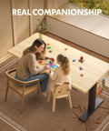 Mother and child play at Adjustable Height Solid Bamboo Standing Desk 60 By 30 Inches With Sturdy Black Steel Frame.