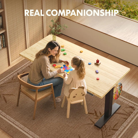 Mother and child play at Adjustable Height Solid Bamboo Standing Desk 60 By 30 Inches With Sturdy Black Steel Frame.