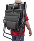 Man carrying folded Legz Up Folding Outdoor Lounger with Adjustable Recline and Leg Elevation for patio, beach, or camp use