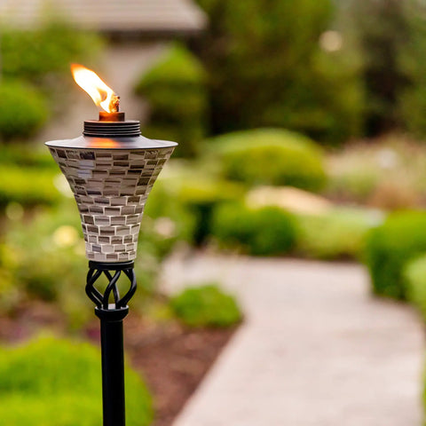 Easy Pour Mosaic Torch For Outdoor Vibes, gray ceramic tile torch with weather resistant steel, lit in garden setting