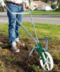 Person using High Wheel Garden Cultivator With Self Cleaning Steel Wheel Hoe And Modular Plow For Gardening in a garden