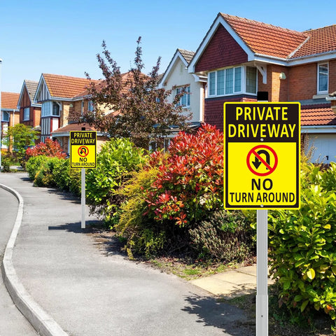 Set of two 14x10 inch aluminum driveway signs, yellow with black text, on long stakes in a suburban street scene