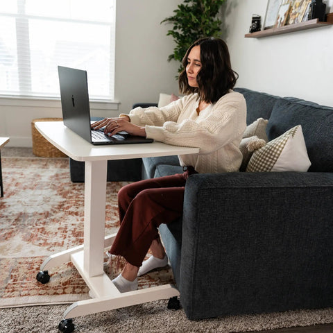 Person using Adjustable Rolling Laptop Desk With Wheels For Home Office Or Classroom Sit Stand Cart, white color