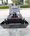 Front view of Mini Skid Steer Loader 1800 Lb Capacity With Four In One Bucket Attachment, parked on concrete.