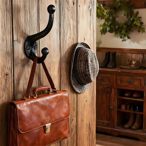 Six Pack Cast Iron Wall Hooks Vintage Black Metal Heavy Duty Coat Rack hanging a leather bag and hats in rustic decor.