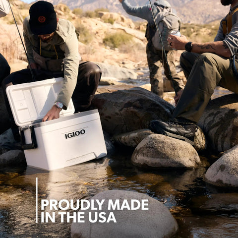 Latitude Marine Ultra White 25 Quart Cooler With Cool Riser Technology ThermoCool Foam Insulation used by anglers by a stream.