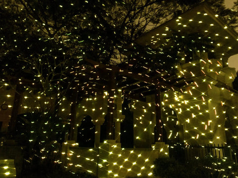 Outdoor setup with Bluetooth Motion Laser Lights With Dope 7 Color Full Spectrum White Star Effects illuminating a gazebo.