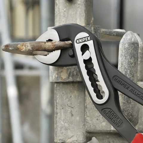12 Inch Alligator Pliers With 9 Position Adjustment gripping metal pipe, slim head design, shown in mechanical application.