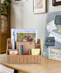 Rattan Desk Organizer With Five Slots Mail Holder And Caddy on wood desk, magazines and pens organized in a wicker basket.