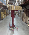 Full Size Manual Hand Winch Work Positioner Lift Truck For Warehouse with package on lift in storage area.
