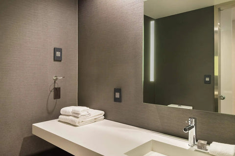 Modern bathroom with Adorne Tamper Resistant Self Test GFCI Outlet 15A Magnesium Finish With Matching Wall Plate