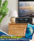 Living room setup with 1000W Bluetooth Home Theater Karaoke Receiver With Five Point Two Channel Stereo Amplifier Dual UHF Wireless Mics PT888BTWM5 on wooden cabinet, showcasing Bluetooth wireless music streaming feature.