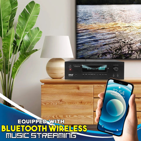 Living room setup with 1000W Bluetooth Home Theater Karaoke Receiver With Five Point Two Channel Stereo Amplifier Dual UHF Wireless Mics PT888BTWM5 on wooden cabinet, showcasing Bluetooth wireless music streaming feature.